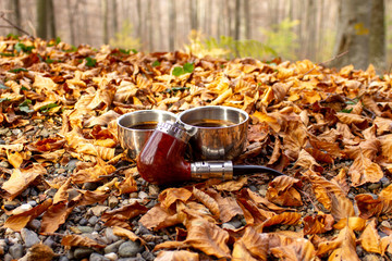 e-pipe with blurred background and cup of coffee in natural ambient. Electronic cigarette, electronic pipe, personal vaporizer, vaping device..