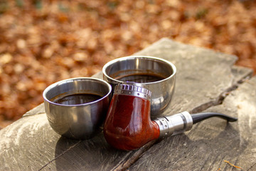 e-pipe with blurred background and cup of coffee in natural ambient. Electronic cigarette,...