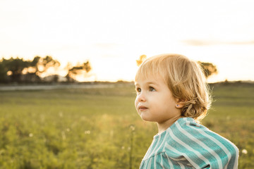Portrait of a little girl in the countryside at sunset