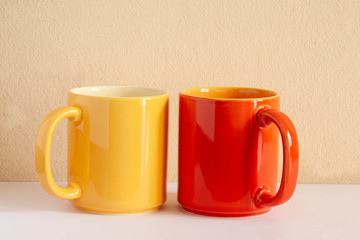 two colored cups on a table with copy space