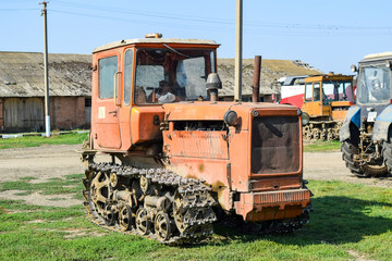 Fototapeta na wymiar Russia, Temryuk - 15 July 2015: Tractor. Agricultural machinery tractor. Parking of tractor agricultural machinery. The picture was taken at a parking lot of tractors in a rural garage on the