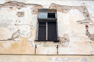 Grungy cement wall and window.
