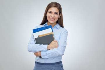 Smiling woman teacher or student holding book, notebook, workbook.