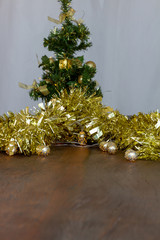 Christmas decoration. Christmas tree, Golden tinsel and lights. Blurred background. Copy Space