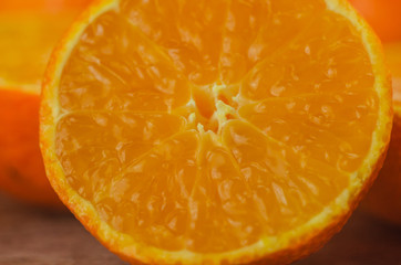 tangerines, peeled tangerine and tangerine slices on a white wooden table