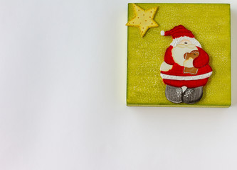 Christmas decoration. Wooden Santa Claus Merry Christmas greeting message. White background. Top view. Copy Space