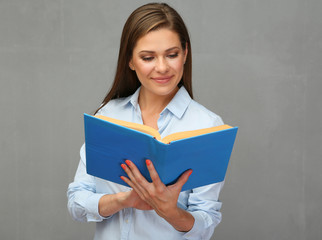 Smiling woman holding open book.