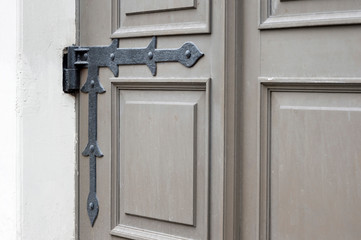 Mount old doors in the form of a hinged wrought-iron hinges antique building. Background