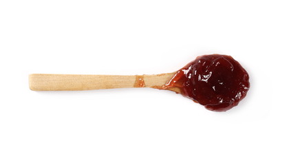 Strawberry jam, marmalade with wooden spoon isolated on white background and texture, top view