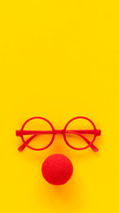 plastic glasses frames and red foam clown nose.