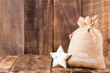 Christmas greeting card wooden background.