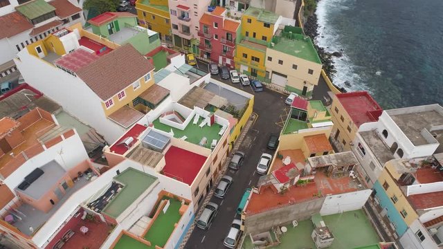 TENERIFE, PUNTA BRAVA, SPAIN - MAY, 18, 2018: Aerial view Atlantic ocean coast and colorful houses .