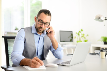 portrait of handsome trendy casual mid age business man in office desk with laptop computer