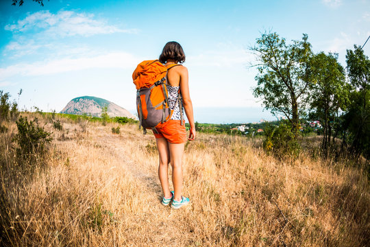A woman is traveling with a backpack.