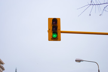 Horizontal image of the traffic lights against the sky