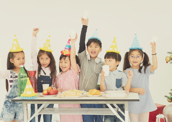 Group of kids celebrate christmas and happy new year party together.