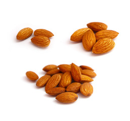 A pile of almond nuts macro view, isolated on white background.