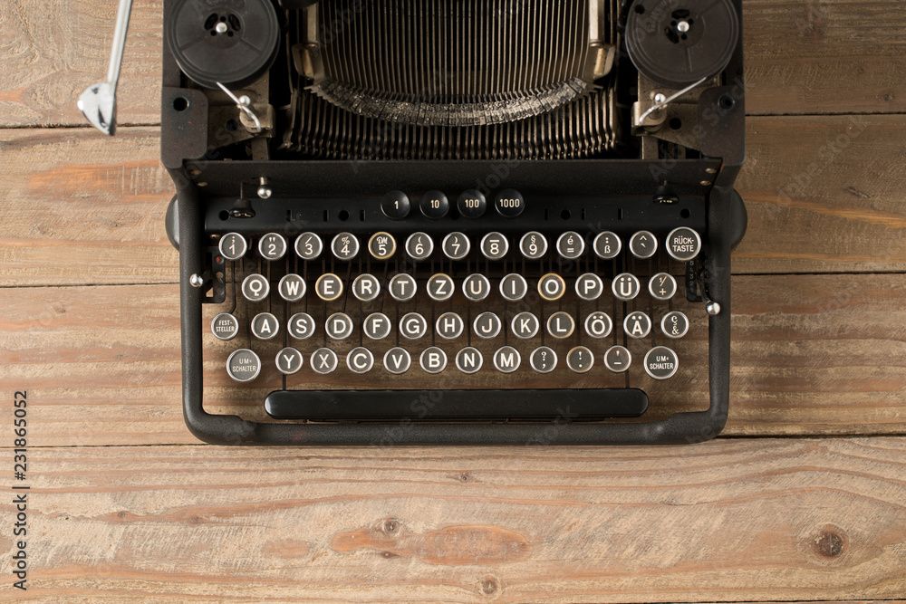 Fototapete top view of retro style typewriter in studio