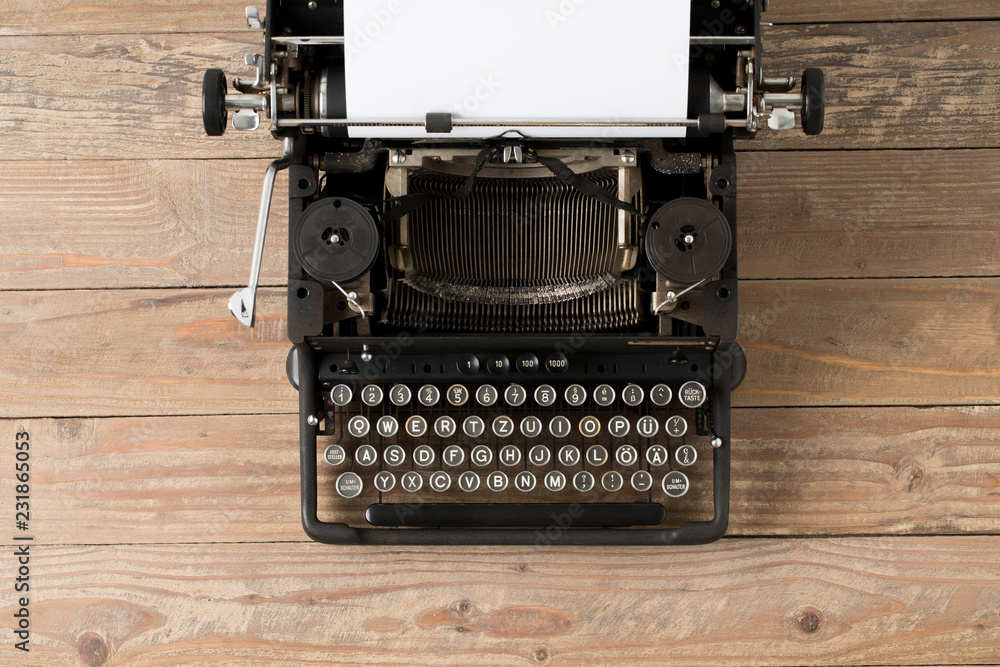 Fototapete top view of retro style typewriter in studio