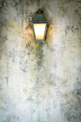 Rough cement wall texture background with a lamp