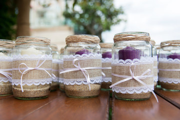 Wedding decoration - candles in glass jars decorated with lace, sackcloth and ribbons