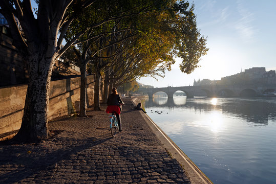 Sunrise and cyclist on the seine river quay in Paris