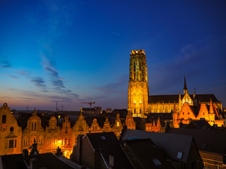 Fototapeta na wymiar Panorama of the illuminated medieval town of Mechelen and the St. Rumbold's Cathedral in the early evening, Belgium
