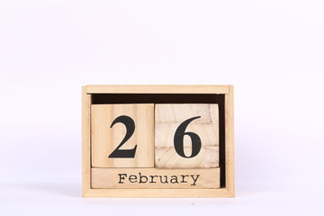 Wooden cubes calendar with the date of February 26. Concept calendar for year with copy space isolated on white background