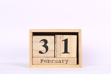 Wooden cubes calendar with the date of February 31. Concept calendar for year with copy space isolated on white background