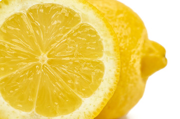 whole lemon and piece on white background