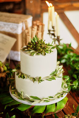 Elegant wedding cake with flowers and decor from green berries. Vegetarian sweets