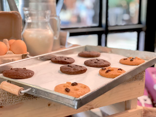 cookie on plate or tray with jar milk and egg at cafe.