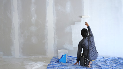 THE  TECHNICIAN painting white color on wall