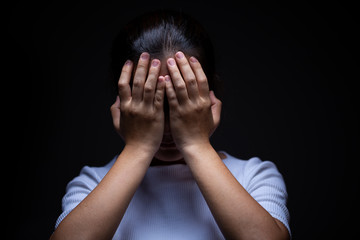 Sadness of a woman in the dark