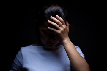 Sadness of a woman in the dark