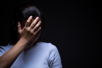 Sadness of a woman in the dark