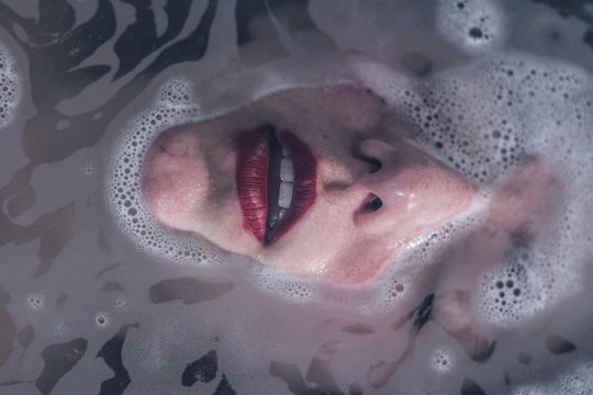 Sensual wet woman with red lips