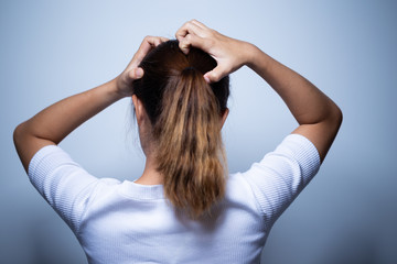 Woman scratching her head