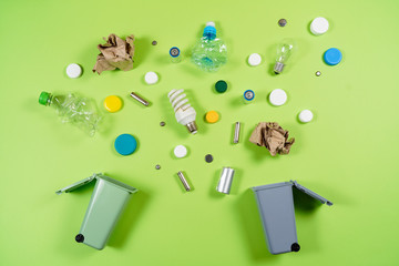 Trash bins and assorted garbage isolated on green, recycle concept,