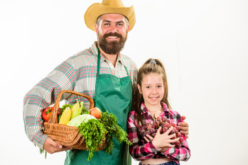 Family farm organic vegetables. Man bearded rustic farmer with kid. Farmers family homegrown harvest. Father farmer or gardener with daughter hold basket harvest vegetables. Gardening and harvesting