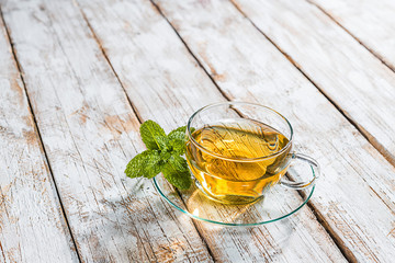 Teacup with mint on an old wooden table
