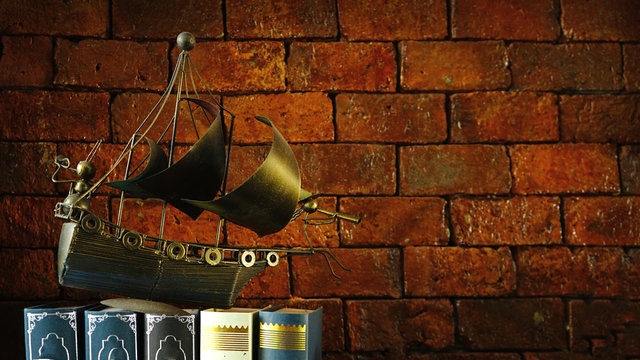 model ship on book . knowledge concept