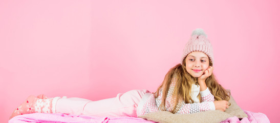 Kid girl wear cute knitted fashionable hat and scarf accessory. Winter fashion accessory. Winter accessory concept. Girl long hair dream pink background. Kid dreamy face wear knitted accessory