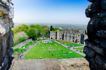 Top view landscape of historical old Castle with long defensive wall in a blue cloudy sky while sun shining