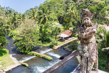 Statue on a bridge over Telaga Waja river on Bali