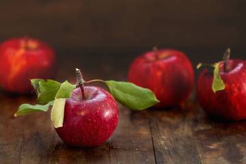 Autumn harvest red apples fruits on a wooden table background