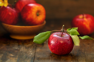 Autumn harvest red apples fruits on a wooden table background