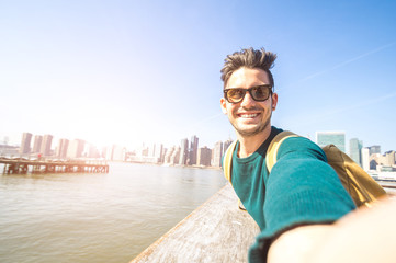 Handsome happy man smiling at the camera taking a selfie at NYC - obrazy, fototapety, plakaty