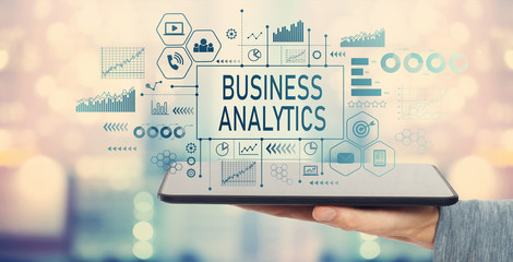 Business analytics with man holding a tablet computer