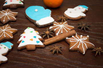 Gingerbread cookies hanging over wooden background